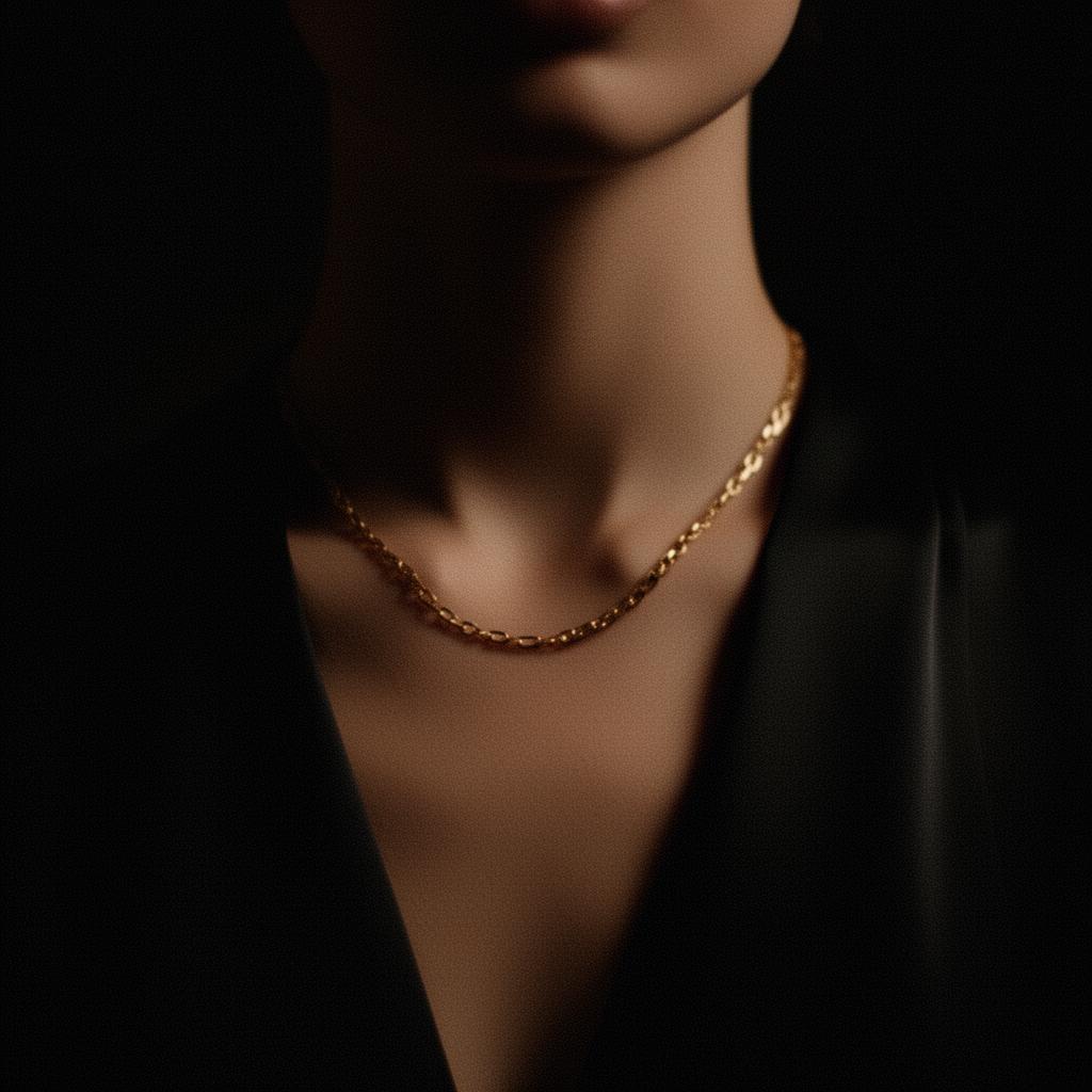 Editorial portrait — gold chain on dark silk